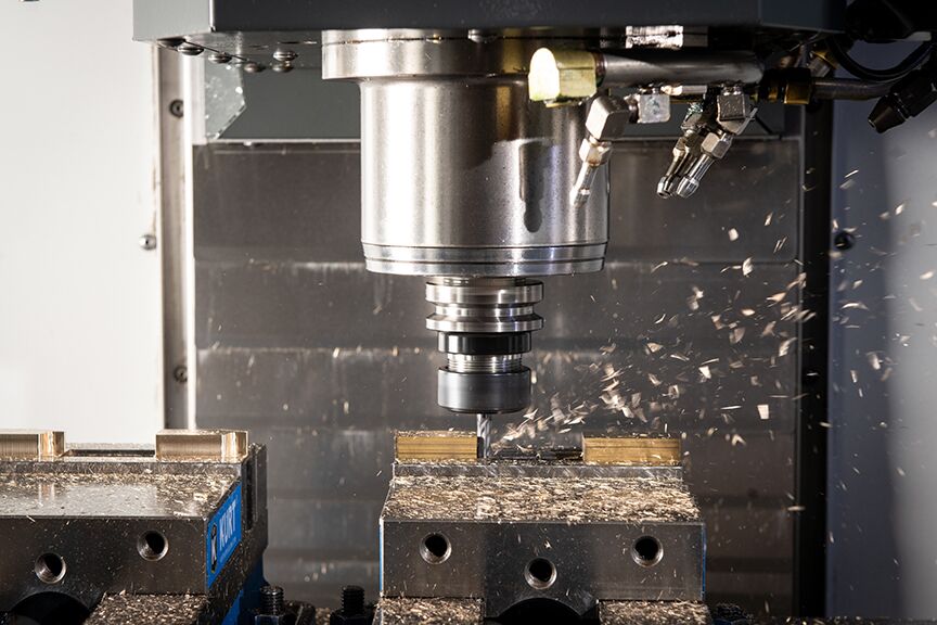 A CNC milling machine operates on a piece of wood, shaping it with precision and efficiency in a workshop setting.